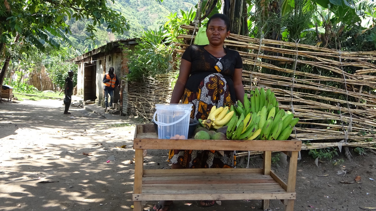A woman sells bananas as part of a small income-generating activity.