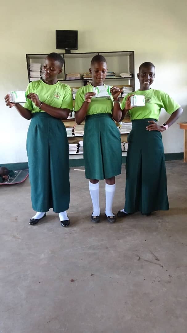 Students pose together after a menstrual hygiene support activity.