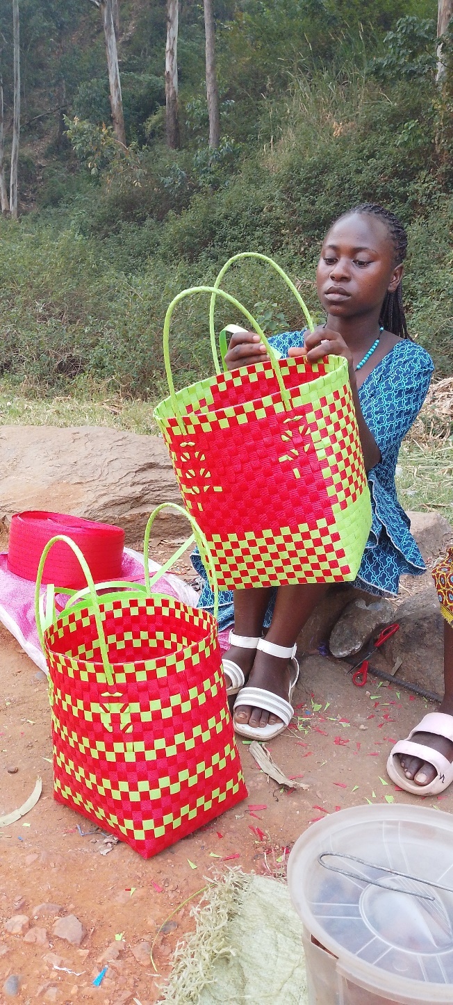 Biira with her weaving business and a bucket of pancakes.
