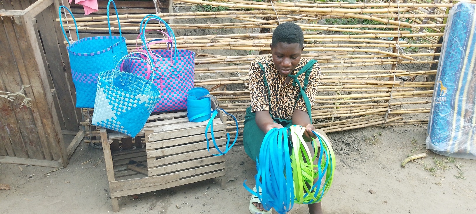 Robina weaving baskets at her home.