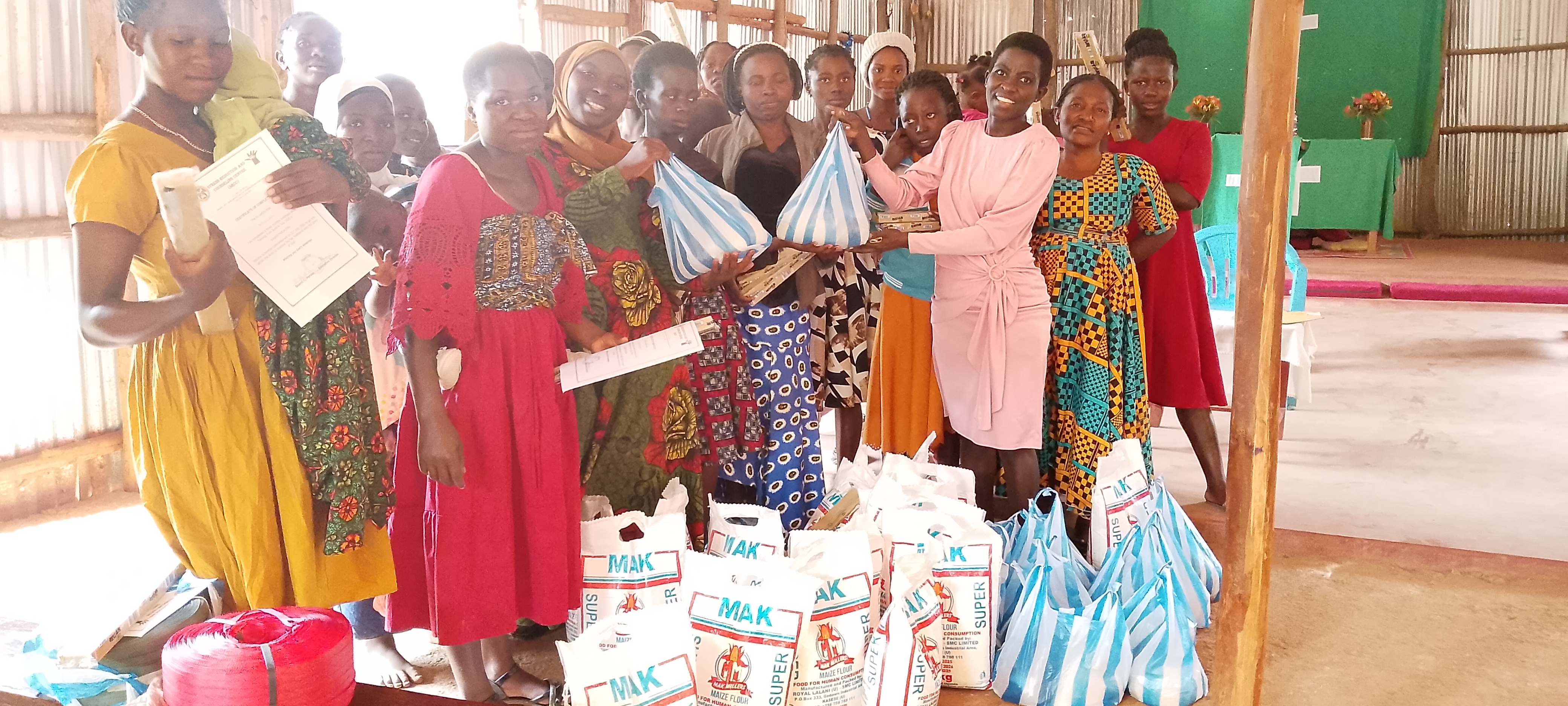 Single young mothers with food support received on graduation day.