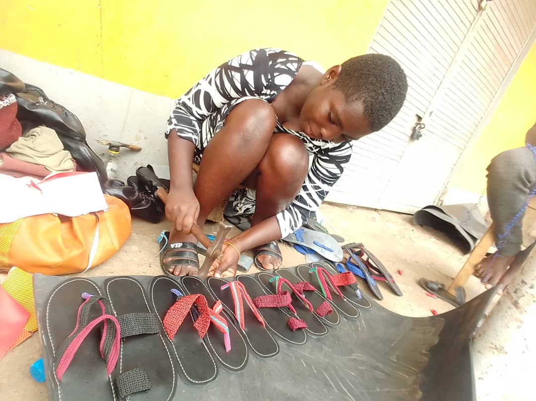 Handmade shoes and craft products displayed together.