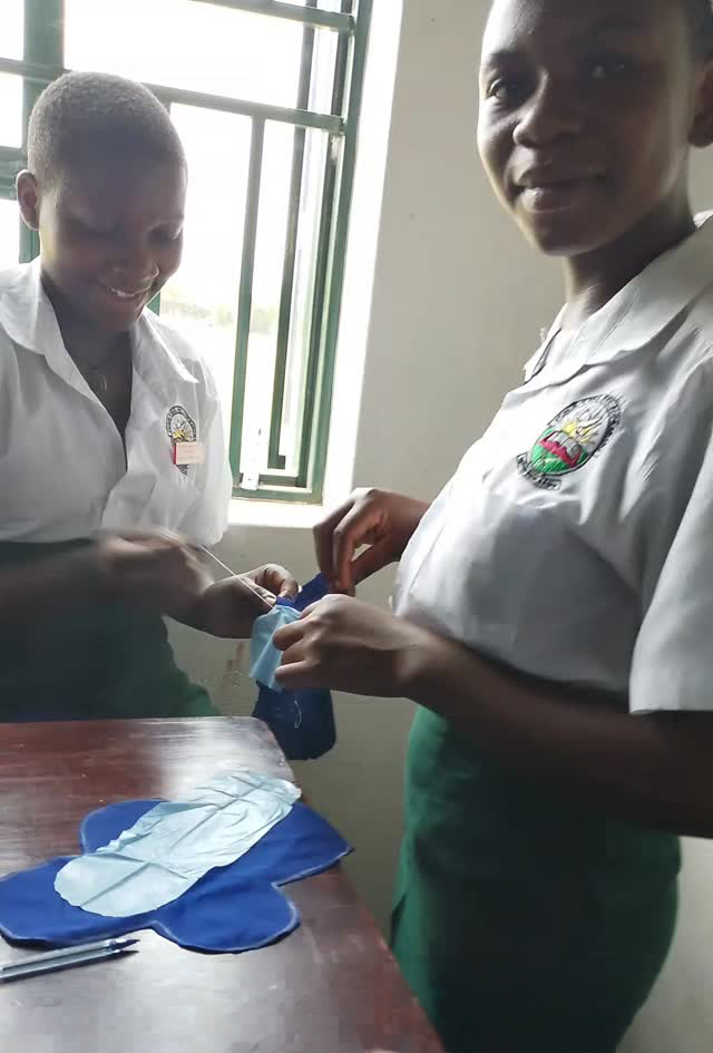 Students learning how to make reusable menstrual pads.